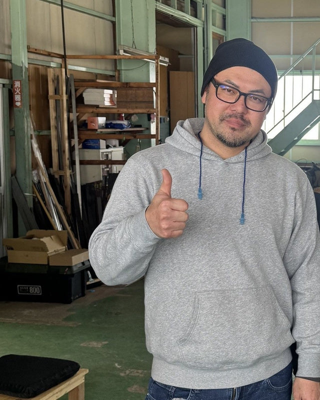 Kisuke Manaka giving a thumbs-up at his Sanjo workshop, February 2026