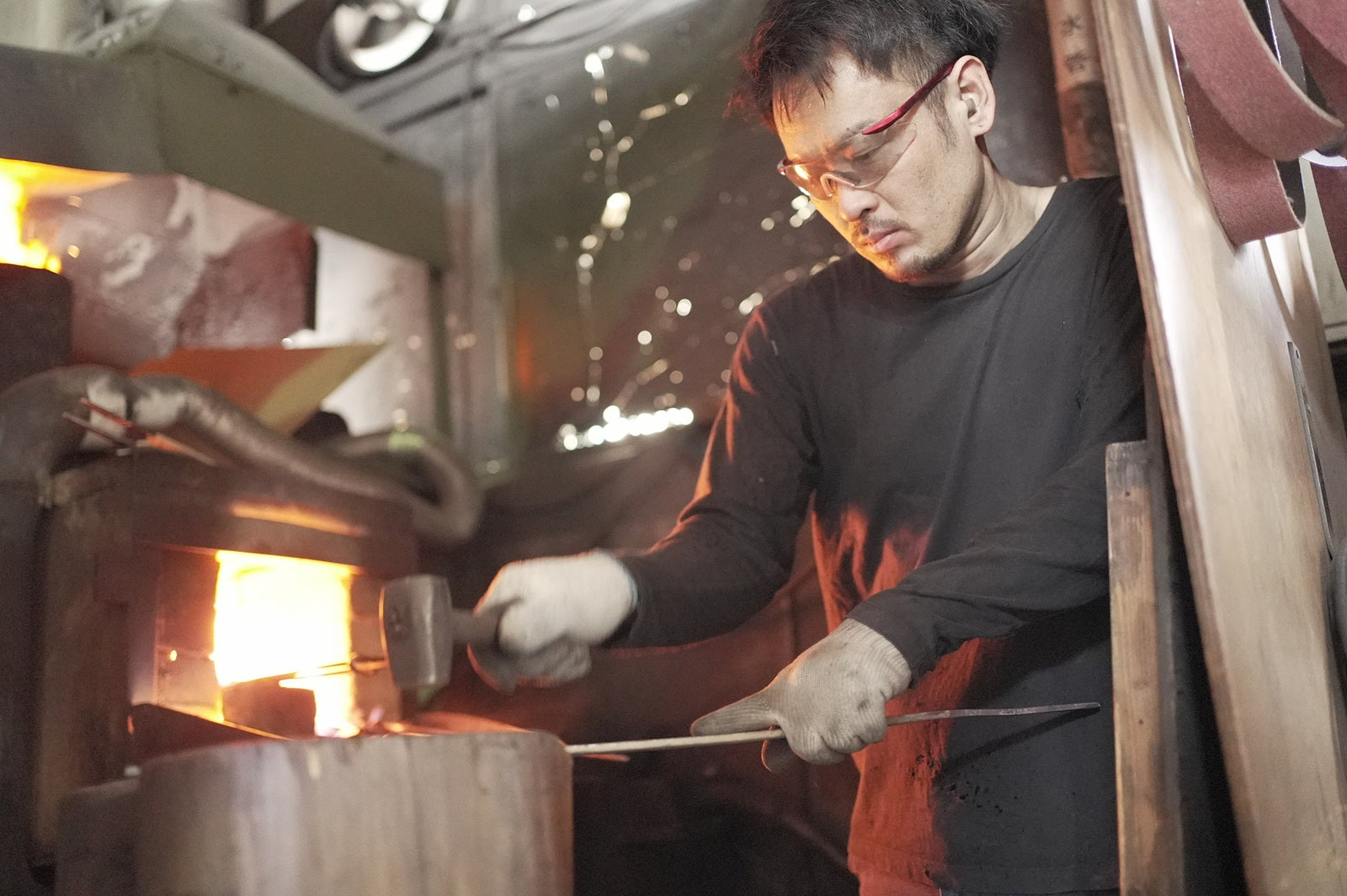 Satoshi Nakagawa hammers glowing steel at the forge in his Sakai workshop.