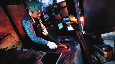 Shigeki Tanaka forging at his workshop in Miki