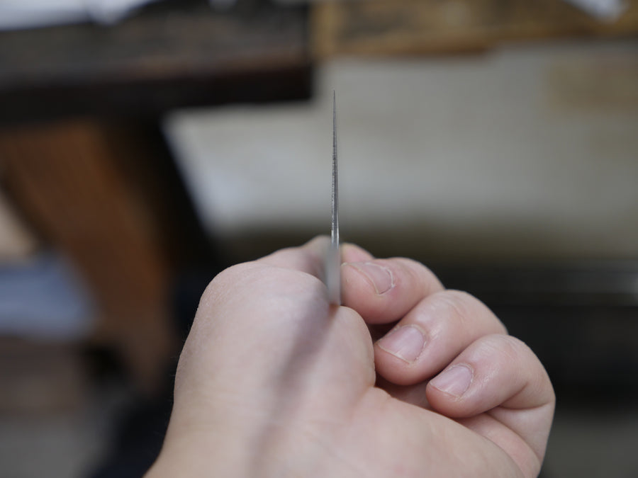 A razor-thin blade edge held up to the camera in Shigeki Tanaka's Miki workshop, 2016