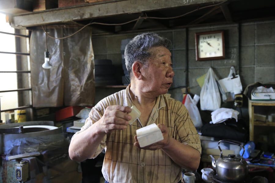 Master Yukinori Oda explaining natural stone basics to James Zhang in the Sakai Takayuki workshop, 2014.